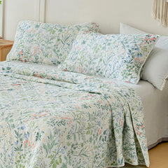 A detailed shot of the quilt from a bed corner angle, showing the design.