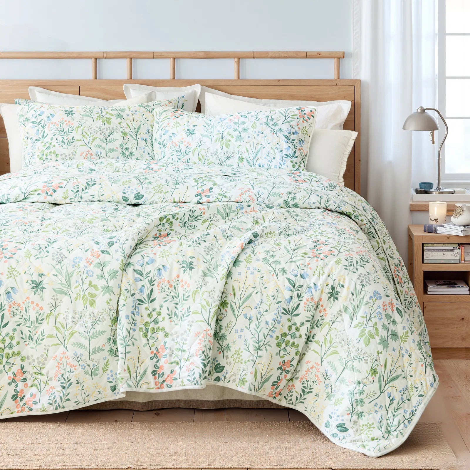 Full view of the vintage green floral quilt set styled on a bed