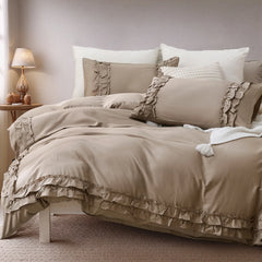Angled view of the warm greige comforter set showing the full bed and pillows