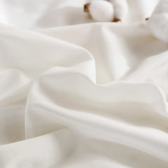 White duvet material detail showing cotton with brown stems