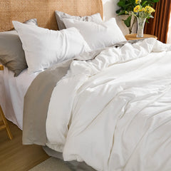 Side top-down view of the complete bedroom layout with the white duvet, pillows, and all decorative elements in frame.