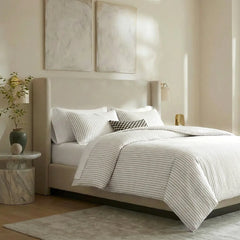 Angled shot of white striped duvet cover on bed