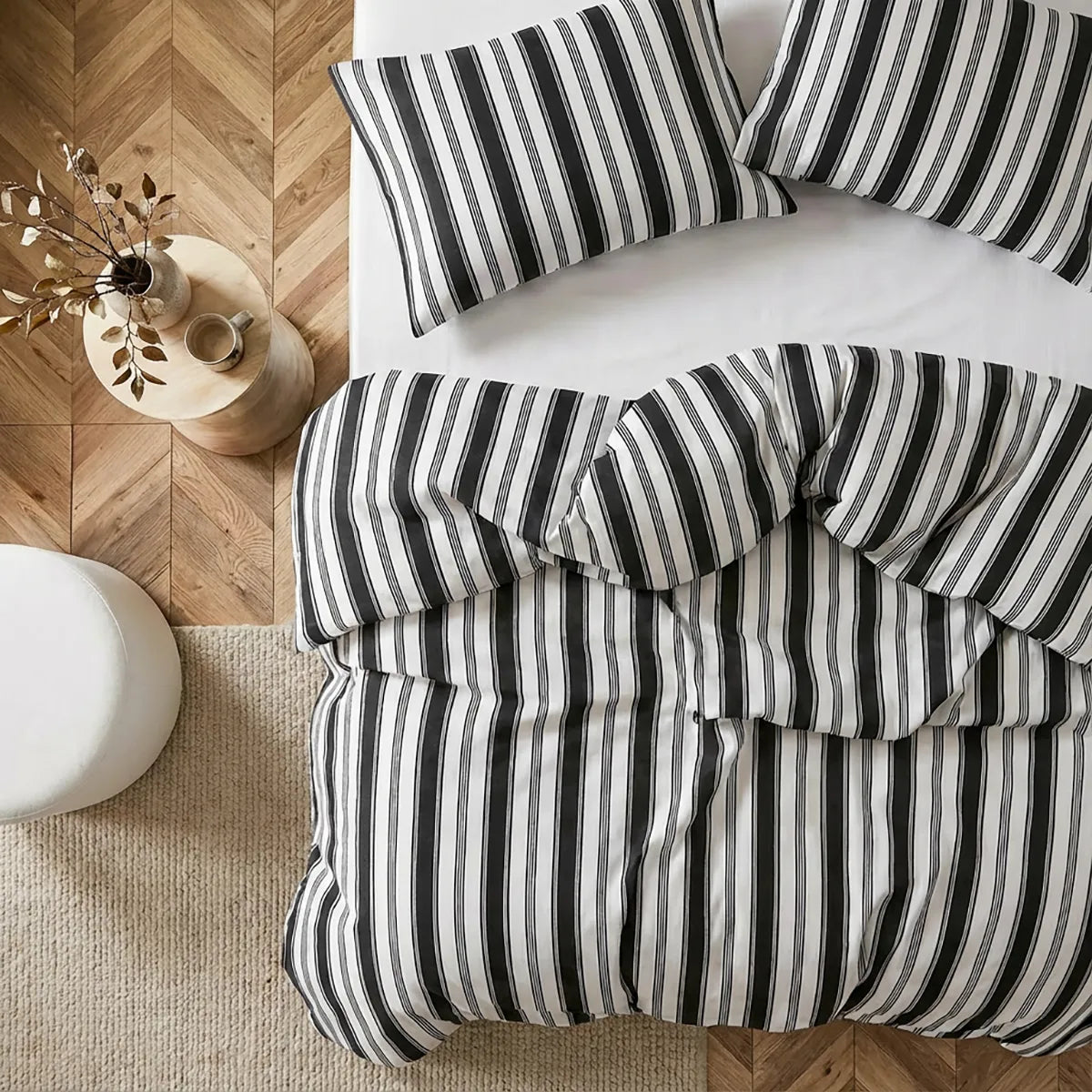 Overhead flat lay of white black grey striped duvet and cases