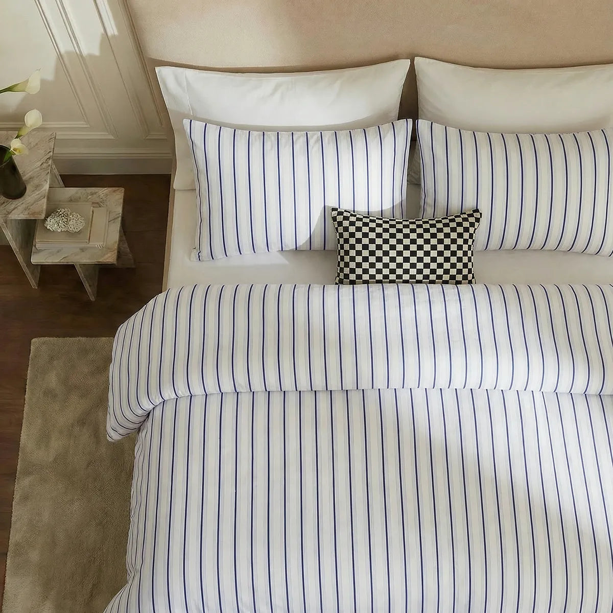 Overhead flat lay of white blue striped duvet and cases