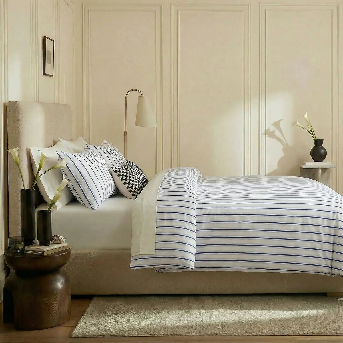 Side view of white blue striped duvet and pillows