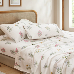 Close up of cotton wildflower print pillowcases and sheet set on modern bed