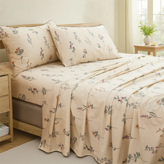 Wildflower ditsy print cotton bedding set on bed with wooden side table and natural light