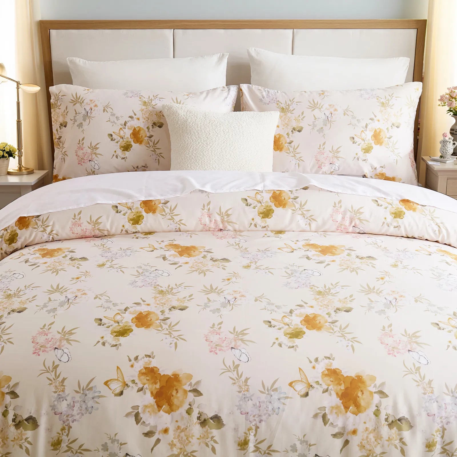 Front view of the yellow floral comforter set on a bed with pillows