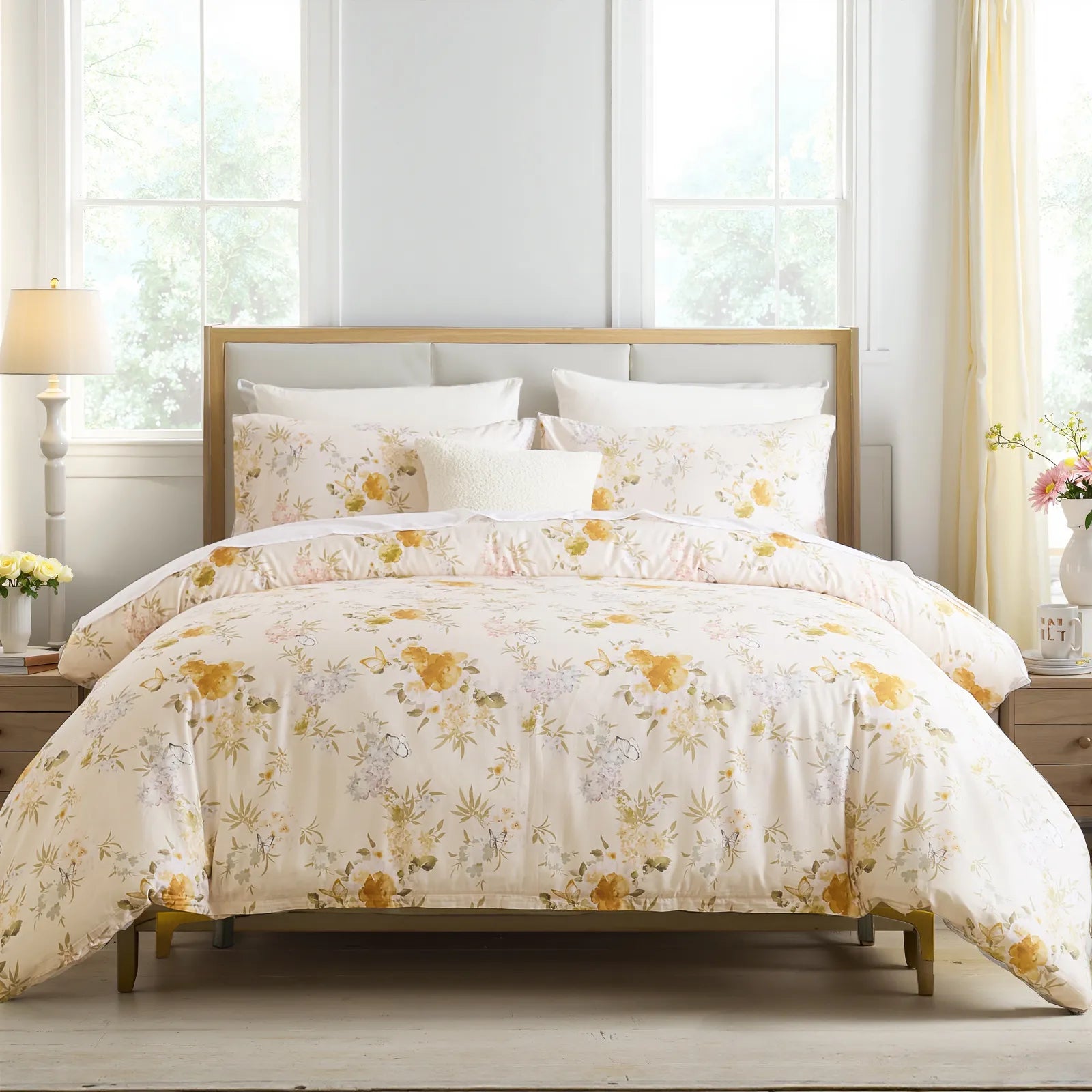 Front view of the yellow floral comforter set on the bed with fluffy pillows