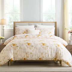 Front view of the yellow floral comforter set on the bed with fluffy pillows