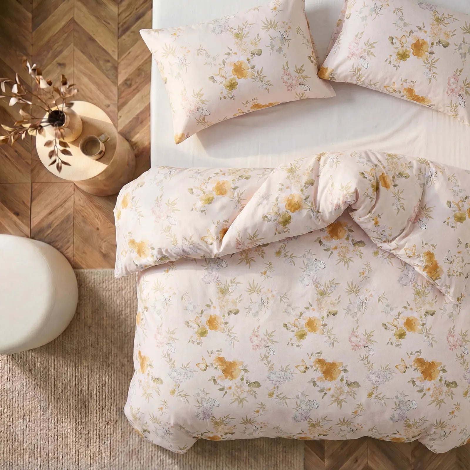 Flat lay top view of yellow floral comforter and pillowcases