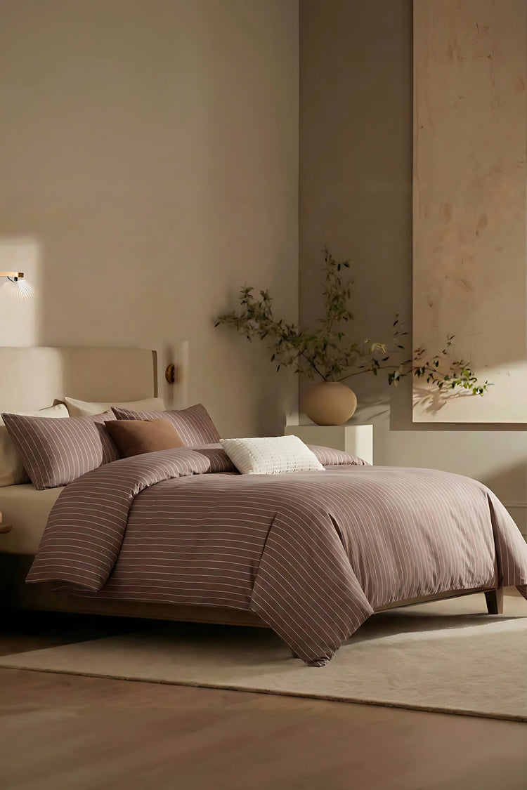 brown striped bedding in a minimalist bedroom