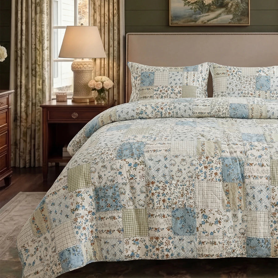 vintage manor patchwork duvet cover set with blue floral and gingham squares in a cozy bedroom