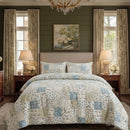 overhead bed view showing the detailed mix of floral and check patterns in the patchwork set