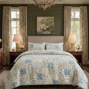 overhead bed view showing the detailed mix of floral and check patterns in the patchwork set