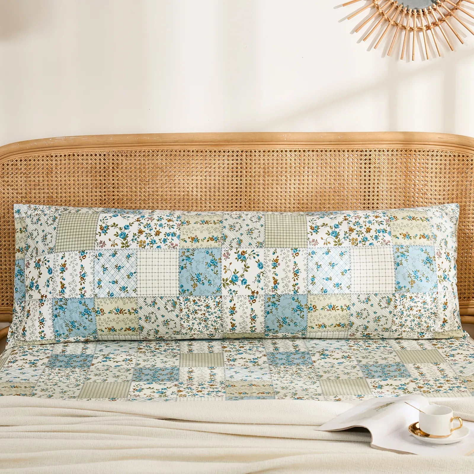Full front view of a long cotton body pillowcase featuring a rustic blue floral patchwork print.