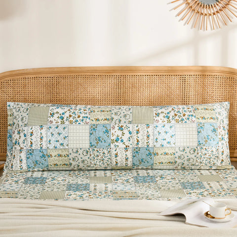 Full front view of a long cotton body pillowcase featuring a rustic blue floral patchwork print.