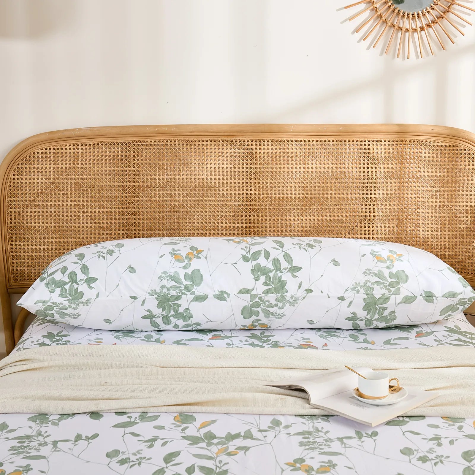 The cotton green leaf body pillowcase displayed horizontally on a bed, showcasing a complete, natural bedroom setup.