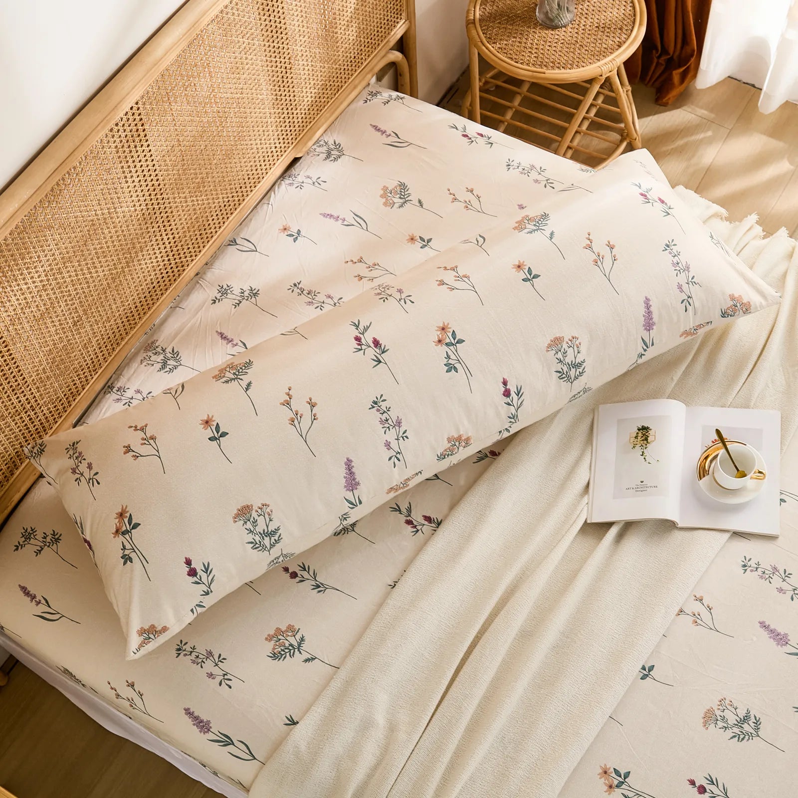 High-angle overhead view of the cotton body pillowcase and fitted sheet with a matching wildflower print on a bed.