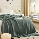 Aqua Knitted Throw Blanket Draped on Bed with Modern Lamp