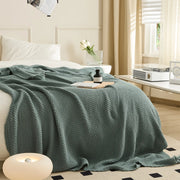 Aqua Knitted Throw Blanket Draped on Bed with Modern Lamp