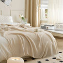 Beige Knitted Throw Blanket Draped on Bed with Modern Decor