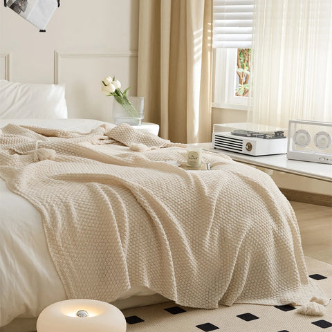 Beige Knitted Throw Blanket Draped on Bed with Modern Decor