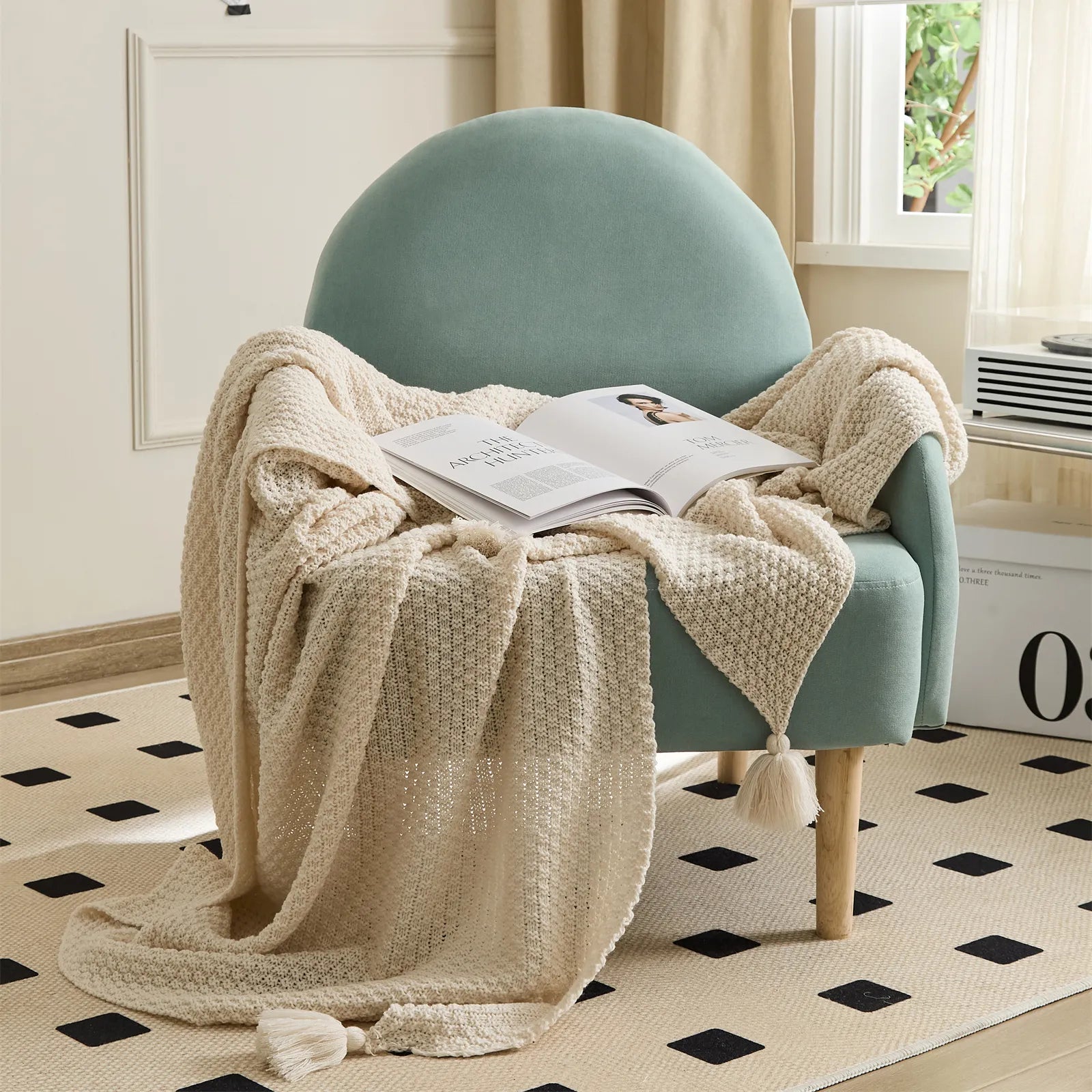 Beige Knitted Throw Blanket on Armchair with Open Magazine