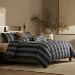 Angled shot of black and grey striped duvet cover on bed