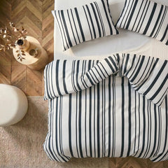 Overhead flat lay of black and white  striped duvet and cases