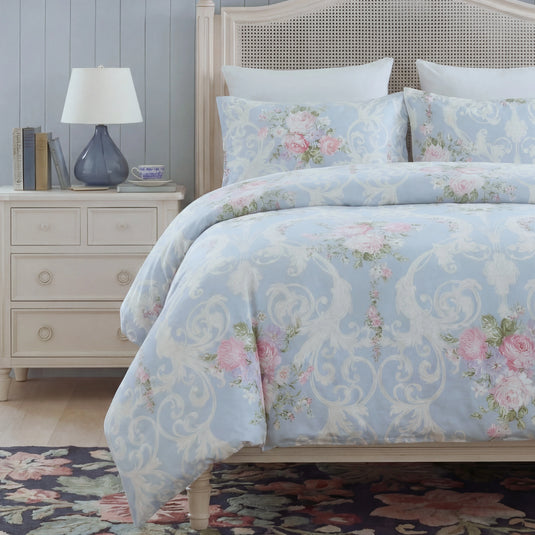 ornate floral comforter in bright bedroom