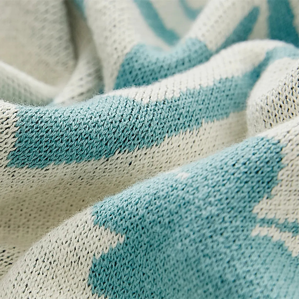 A close-up shot of the blue bohemian blanket, highlighting its soft 100% cotton fabric and intricate woven pattern