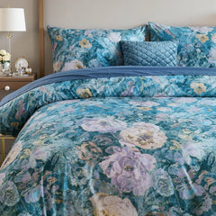 Elegant blue botanical duvet cover set beautifully arranged on bed