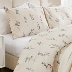 Close-up, side view of the comforter and pillow showing the small, detailed floral pattern.