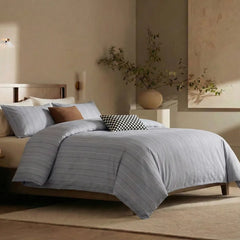 Angled shot of blue striped duvet cover on bed