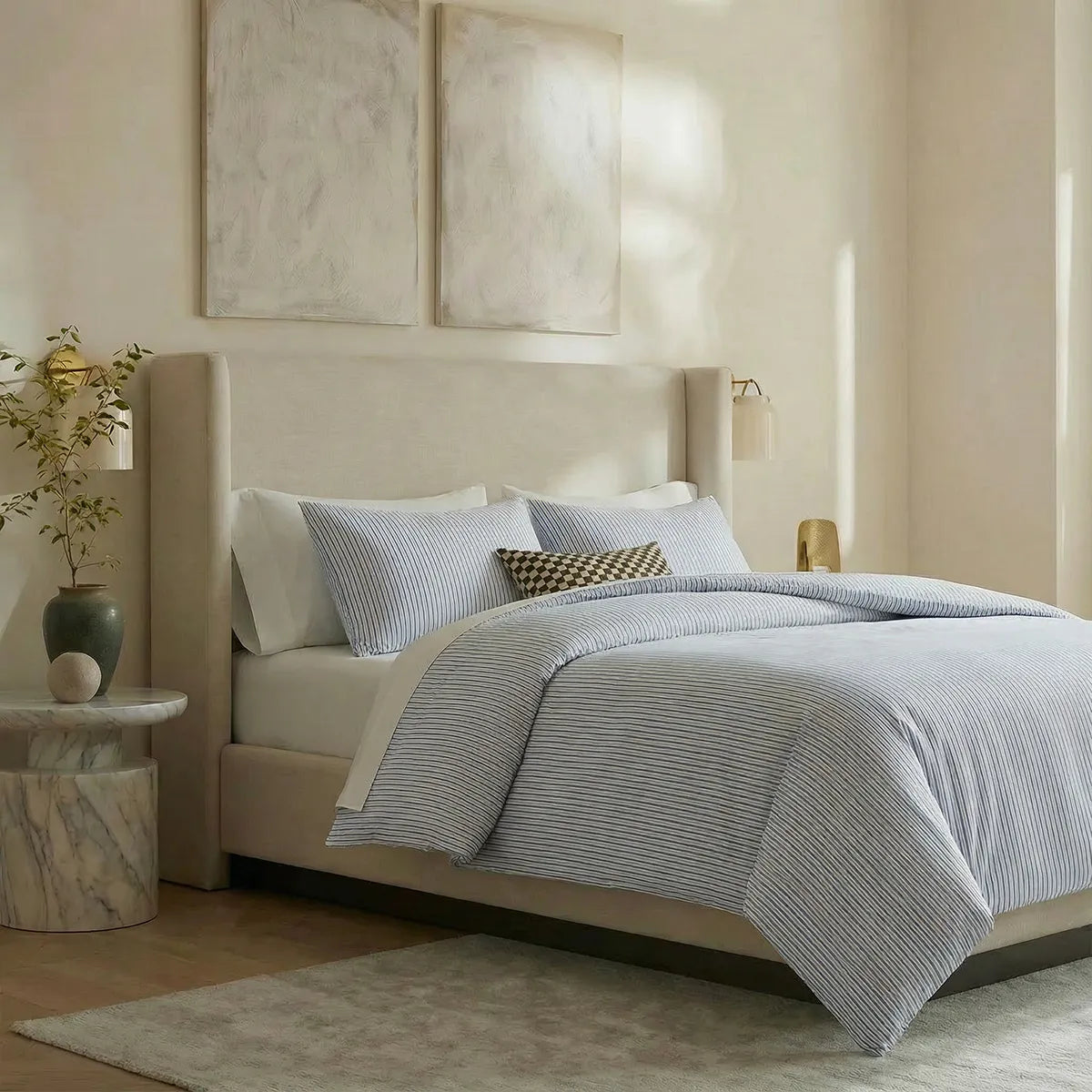Angled shot of blue and white striped duvet cover on bed