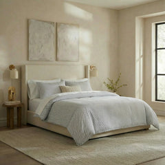 Angled shot of blue and white striped duvet cover on bed