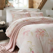 pink lily floral duvet set styled with chunky knit throw blanket in cozy bedding scene