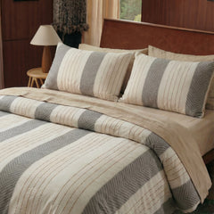 neutral bedding set styled on bed