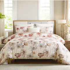 Comfortable floral duvet cover on the bed, bright bedroom with wooden headboard and bedside table