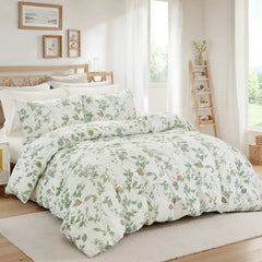 The green leaf duvet cover set styled on a bed in a modern, light-filled room