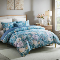 Full display of blue botanical duvet cover set with floral patterns and lace details on bed