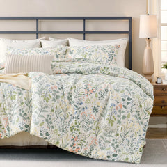 Vintage green floral cotton duvet cover on bed with geometric metal headboard and plant