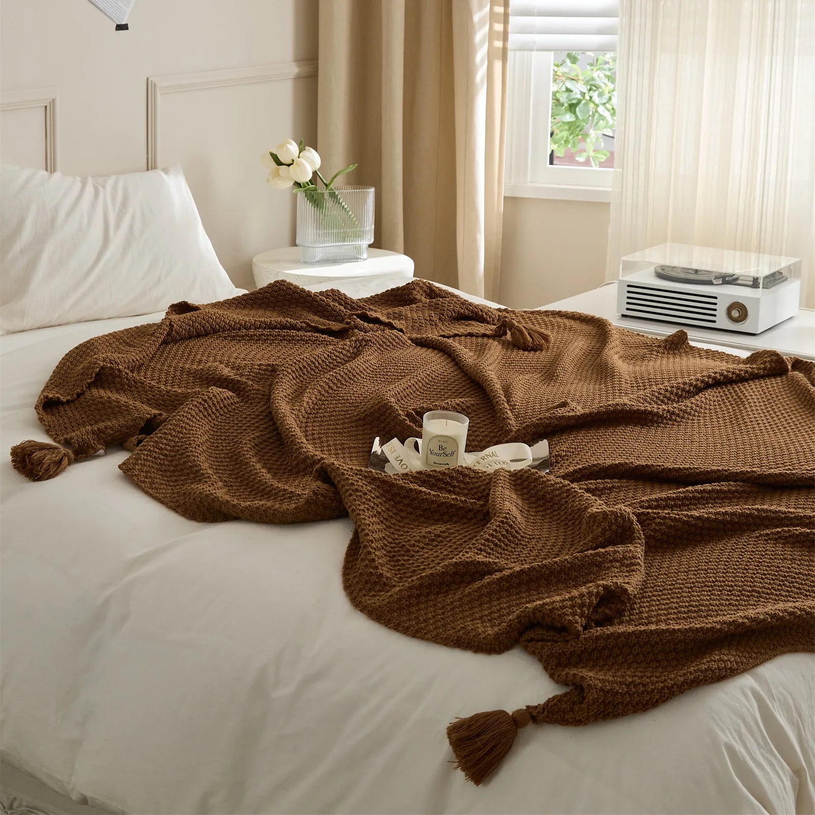 Brown Knitted Throw Blanket on Bed with Candle and Decorative Tray