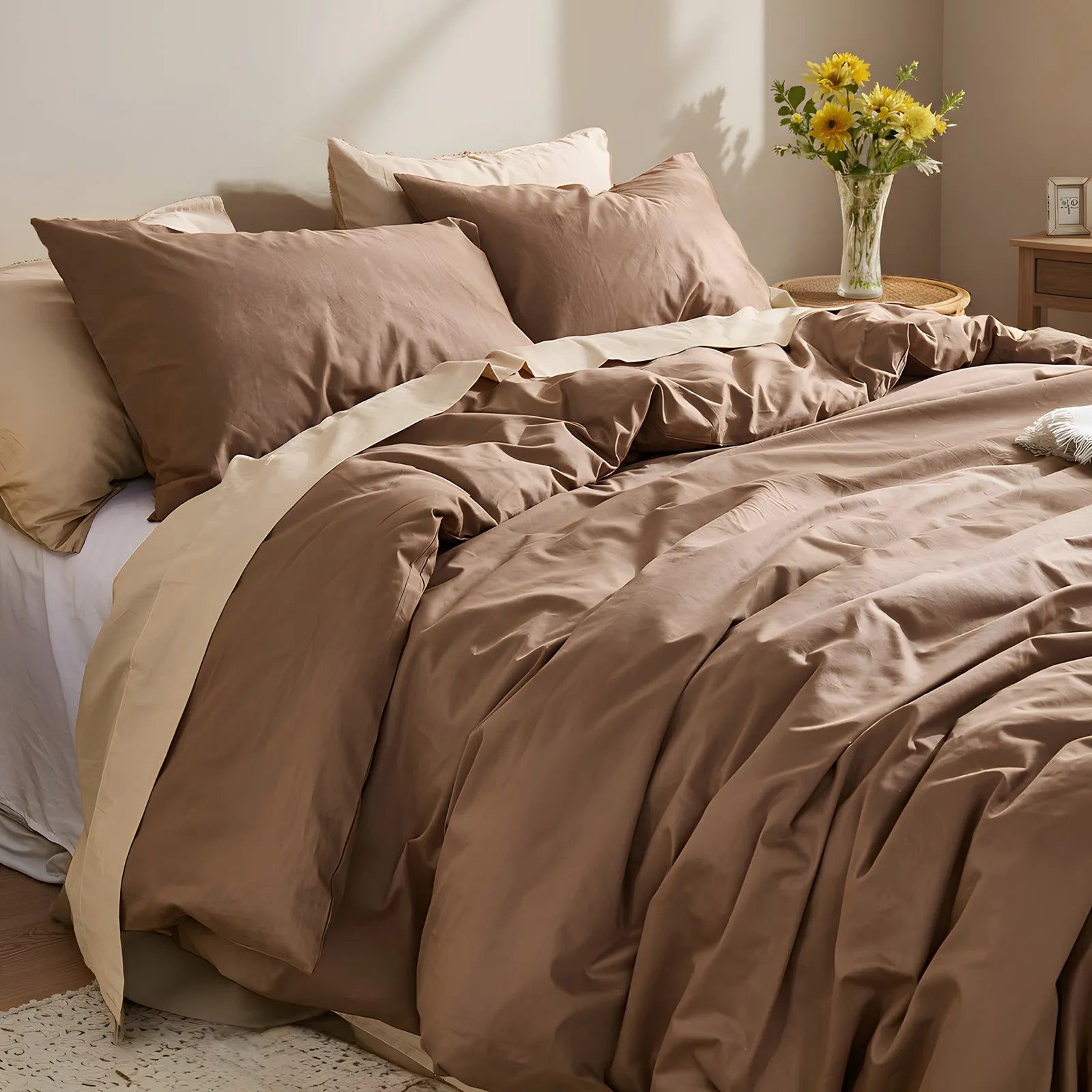 Overhead view from headboard showing brown duvet texture with sunflowers on woven nightstand.