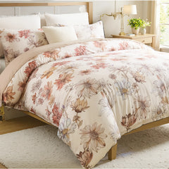 Vibrant multicolor floral pillows and duvet set with gold nightstand and green plants