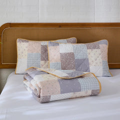 The cottage cotton floral quilt set folded neatly for display.