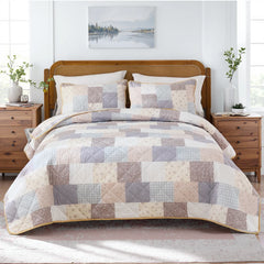 Full view of the floral cottage quilt set on a bed in a cozy bedroom