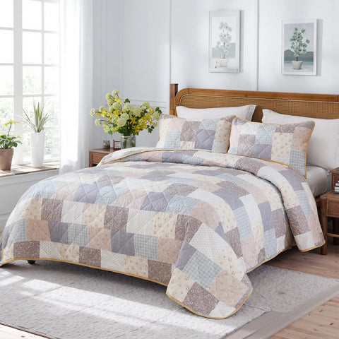 The cottage floral quilt set styled on a bed in a modern, light-filled bedroom.