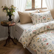 close-up of colorful wildflower sprigs on ivory cotton duvet cover fabric detail